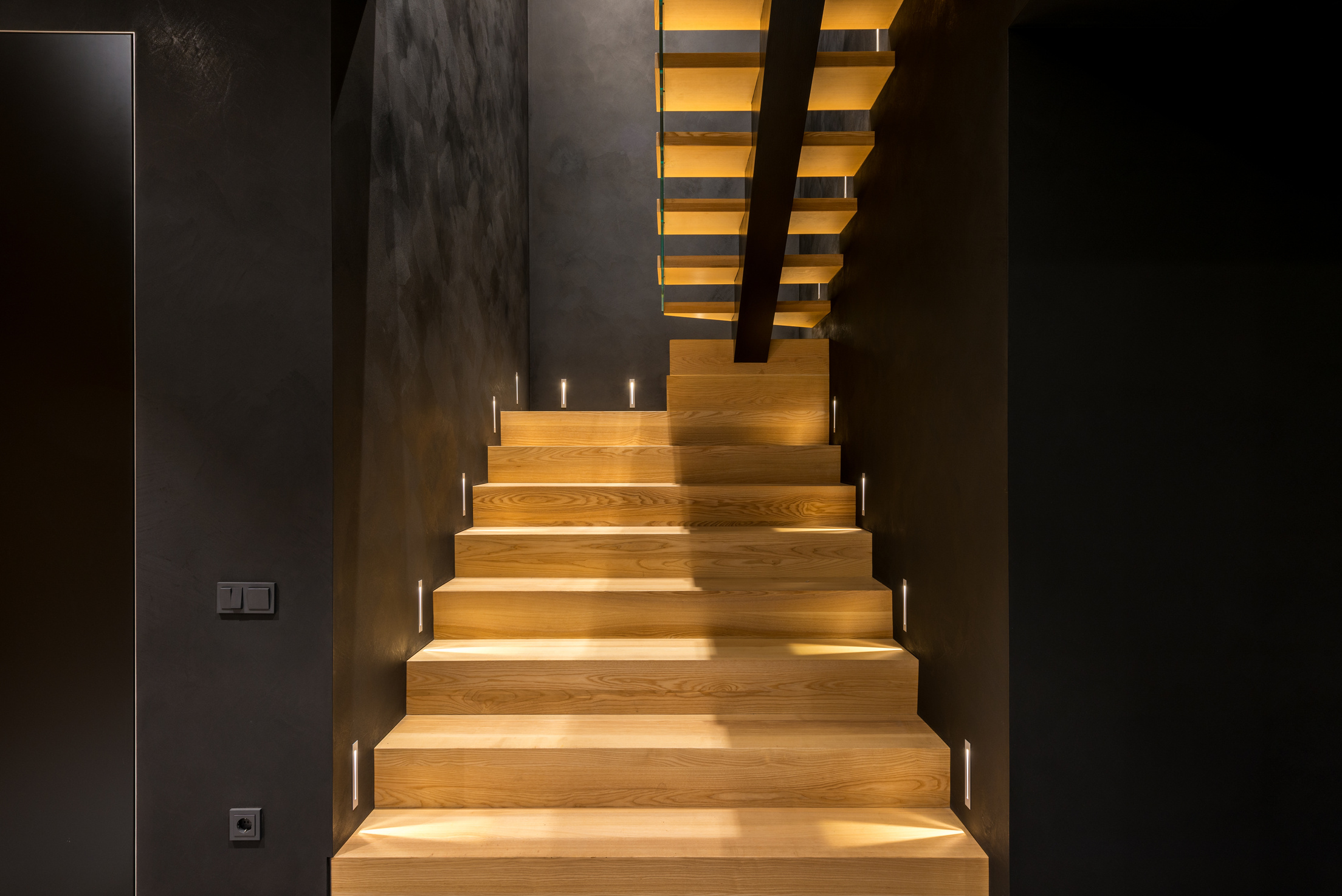 Illuminated staircase in light modern house
